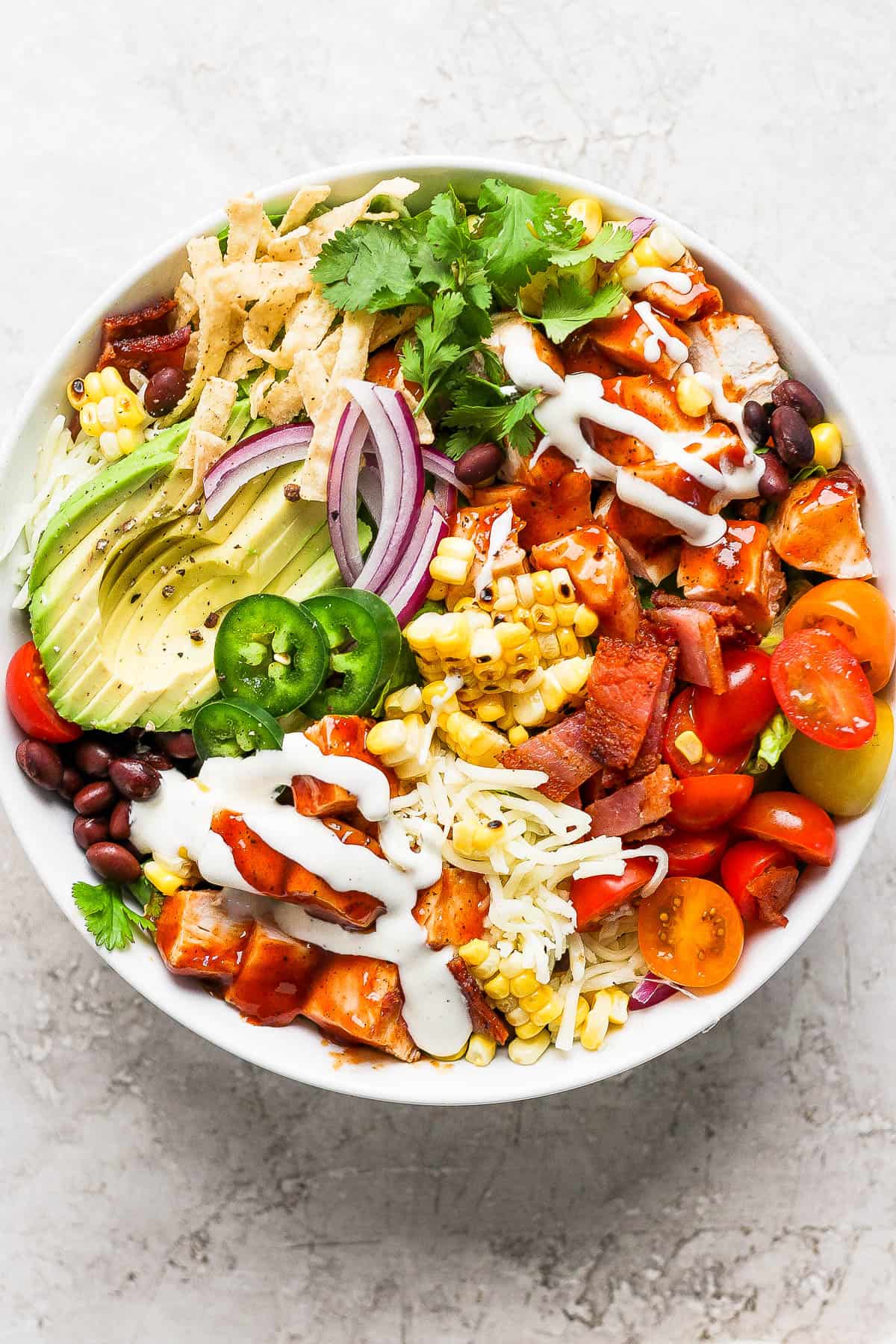 A large bbq chicken salad with all of the toppings and ranch dressing.