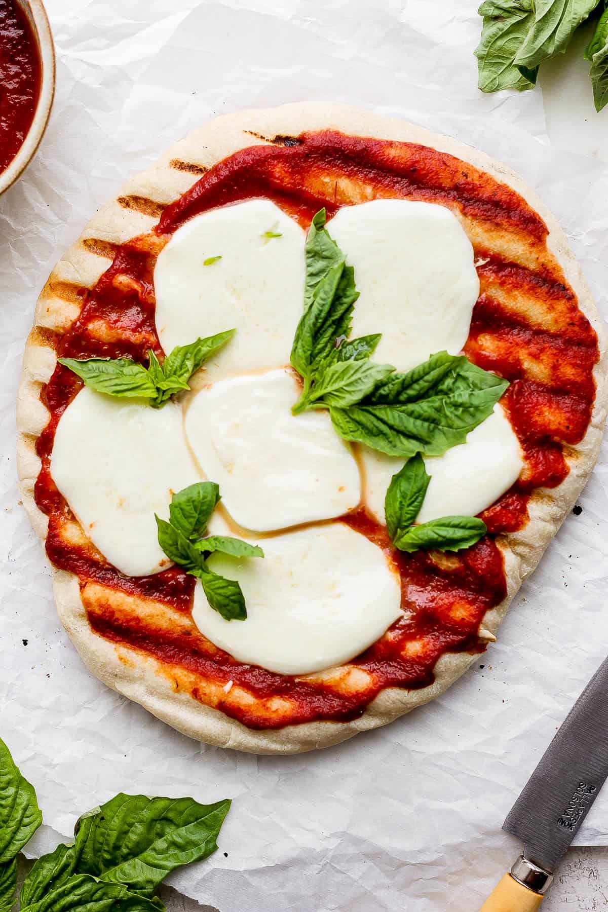 A fully cooked grilled margherita pizza.