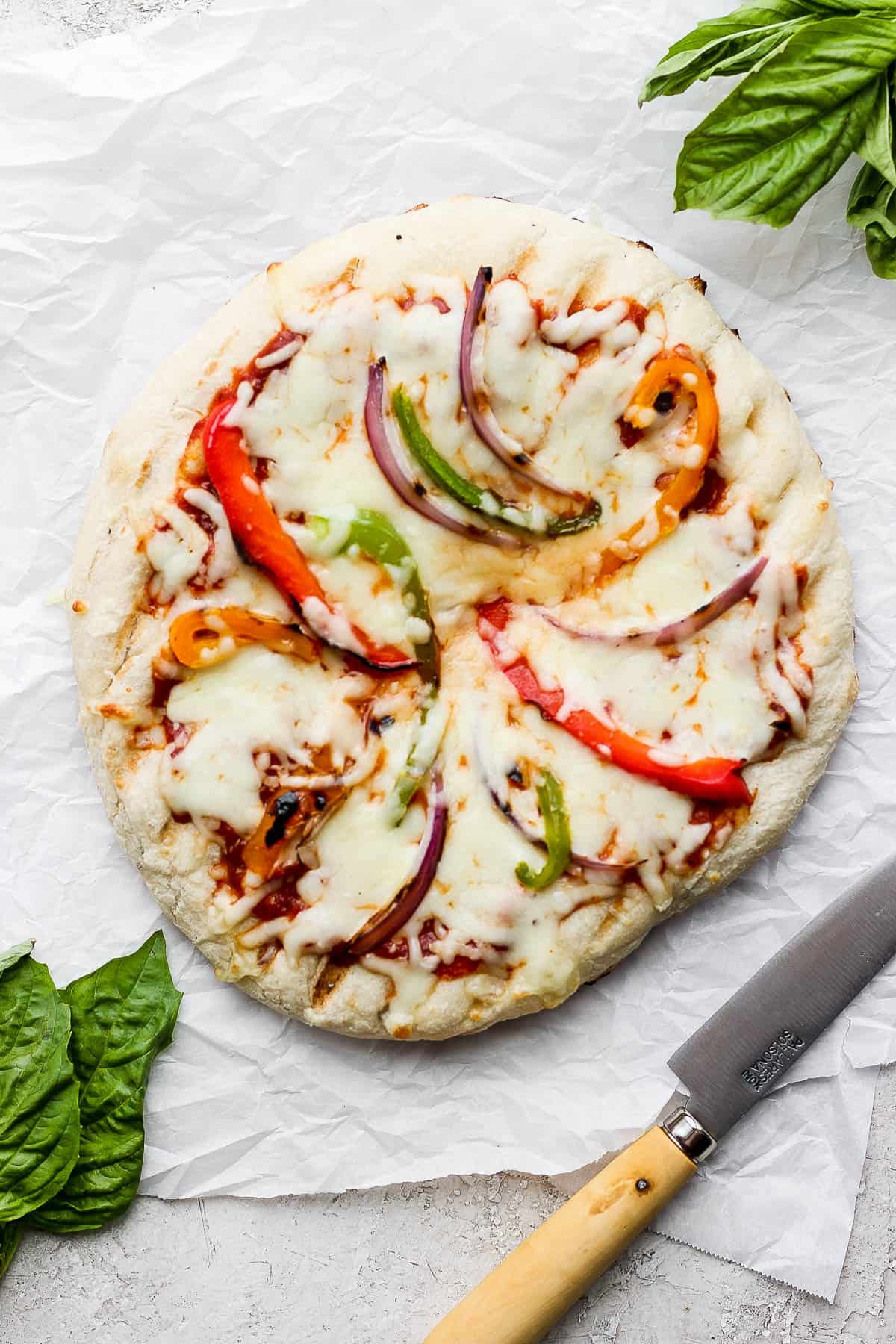 A fully cooked, grilled veggie pizza.