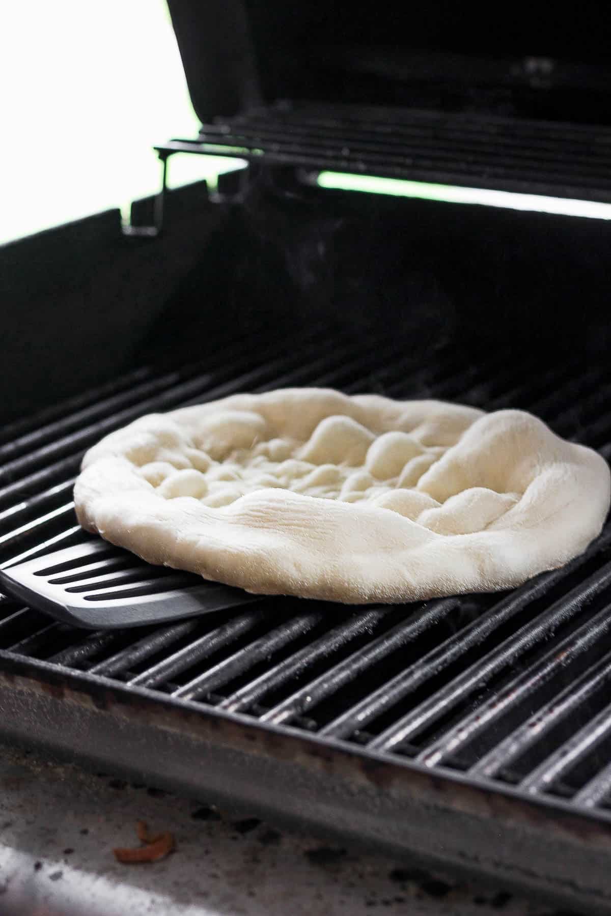 Pizza crust on the grill after cooking for the first 2-3 minutes.