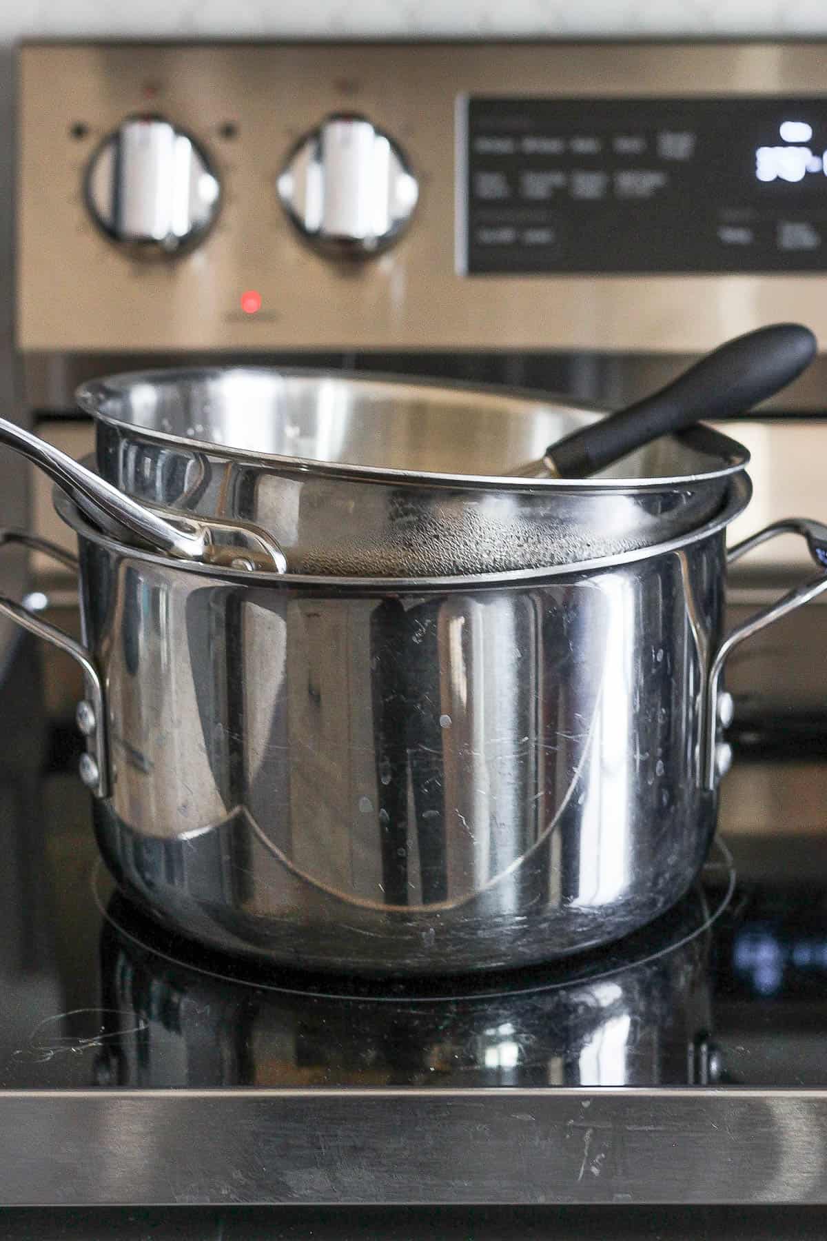 A double boiler on the stovetop.