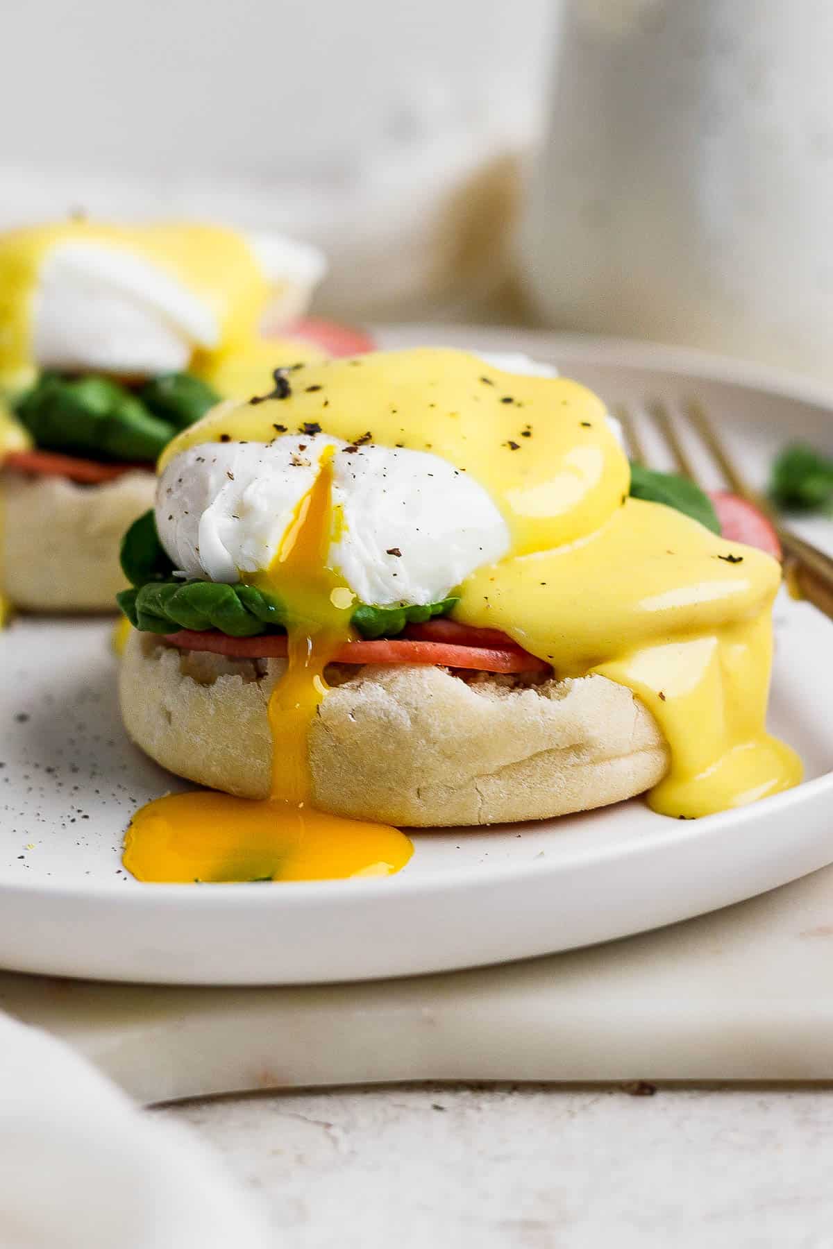 Hollandaise sauce over some eggs benedict.