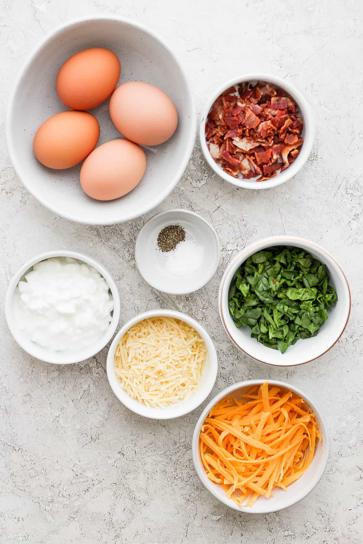 Ingredients for instant pot egg bites in separate bowls.