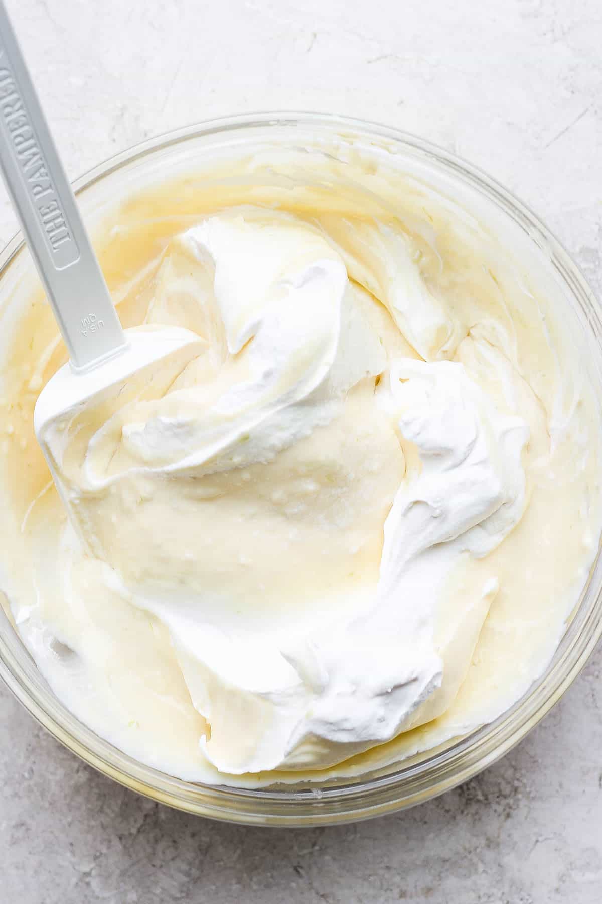 Cream cheese, lime juice, lime zest, cool whip and sweetened condensed milk in a mixing bowl.