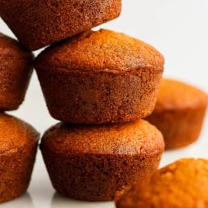 Five cornbread muffins piled up on top of each other.