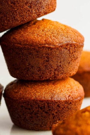Five cornbread muffins piled up on top of each other.