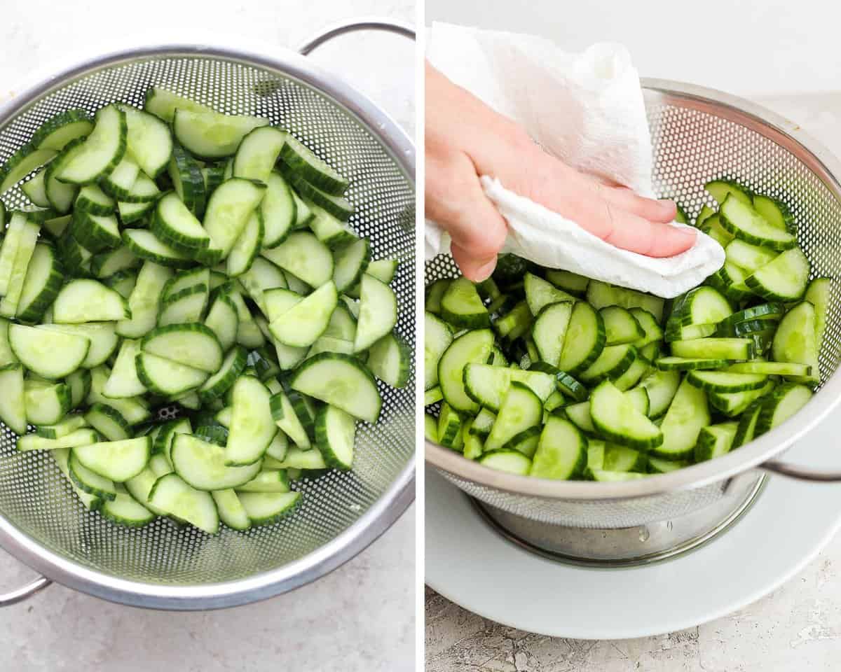 Sliced and halved english cucumber in a colander being patted dry with a clean paper towel.