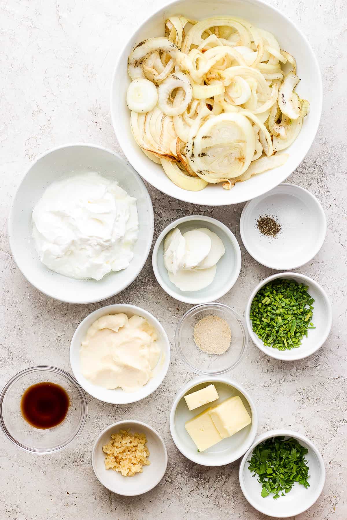 French onion dip ingredients in separate bowls.