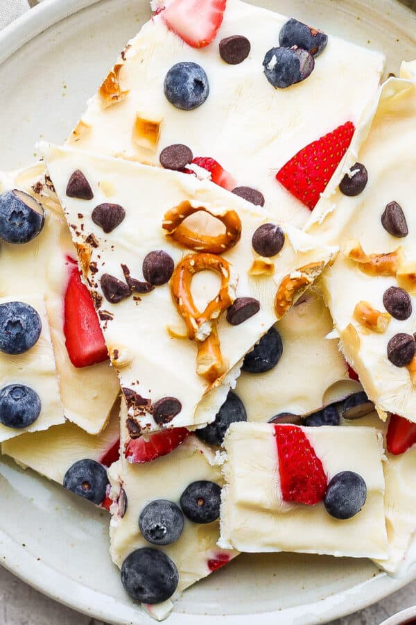 Top down shot of a plate of frozen yogurt bark pieces.
