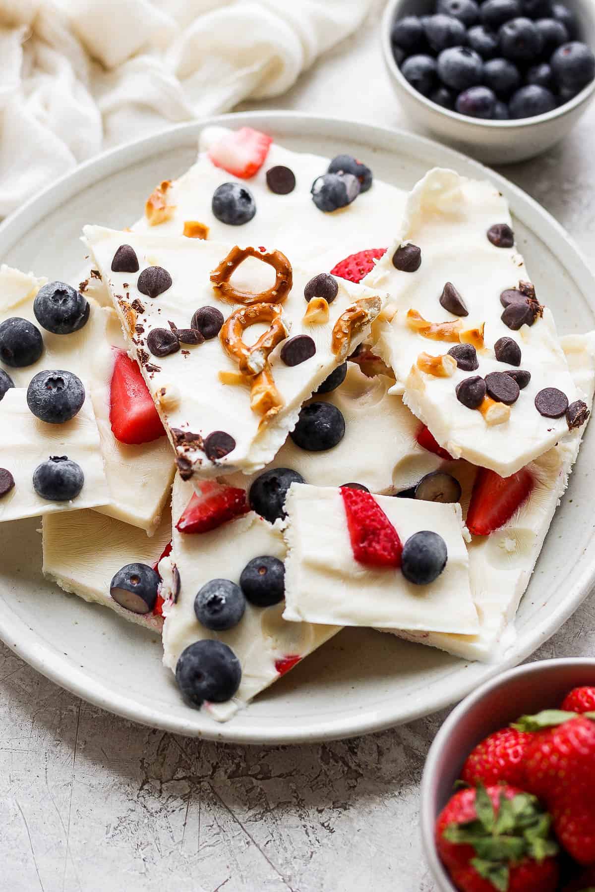 A plate of frozen yogurt bark pieces. 