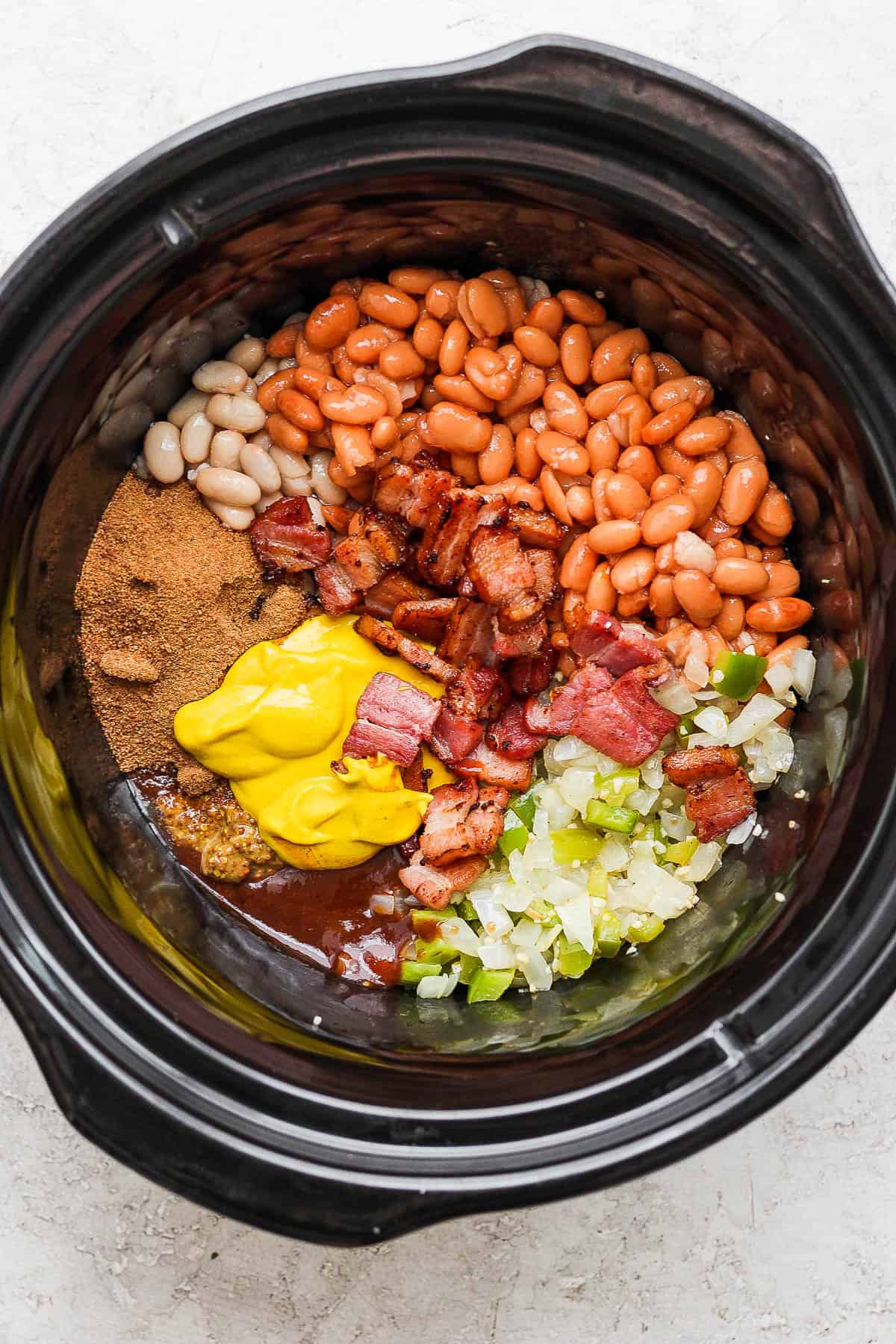 All of the baked beans ingredients in the slow cooker.