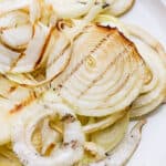 A plate of smoked onions with char marks.