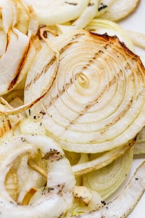 A plate of smoked onions with char marks.