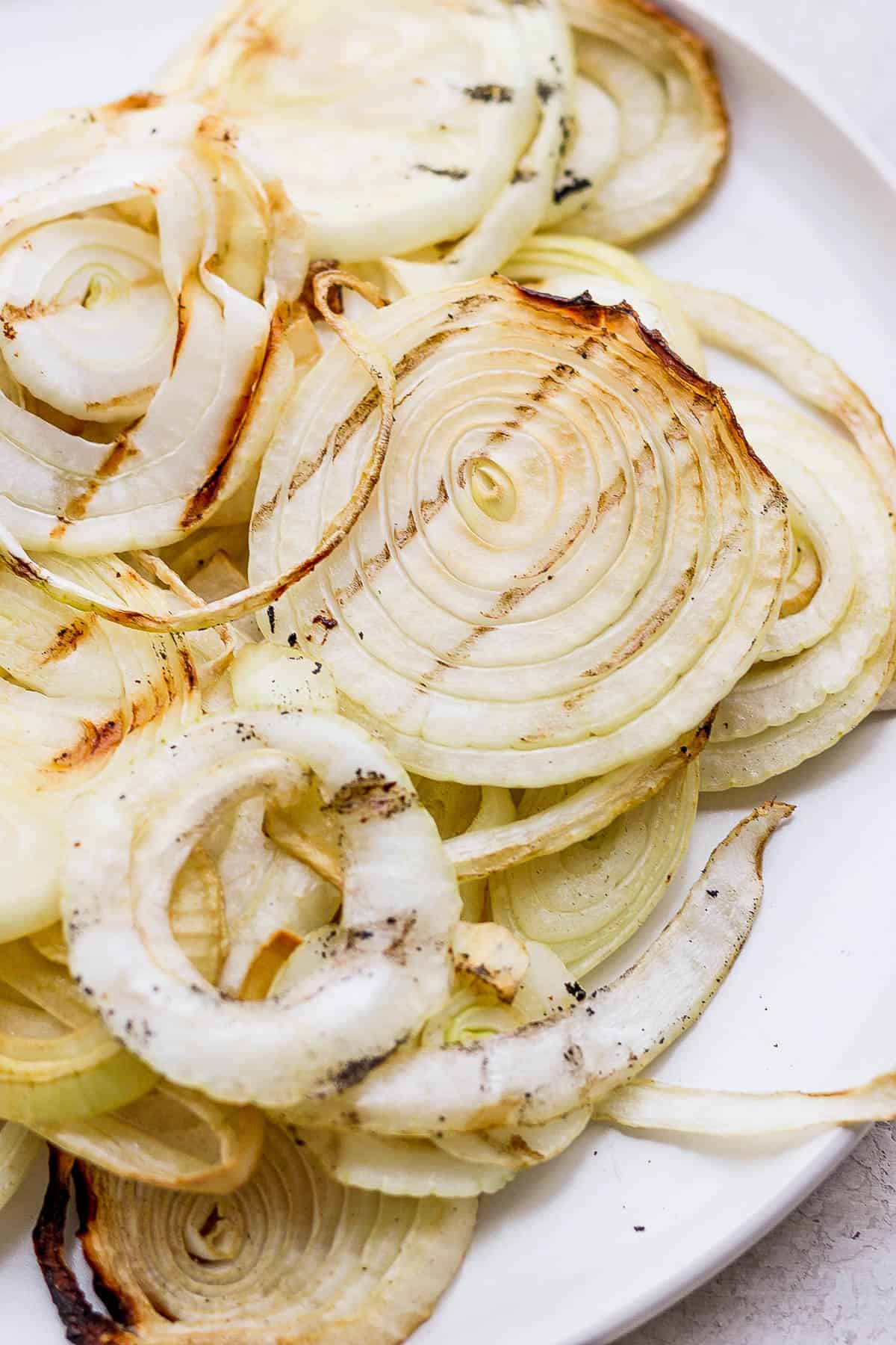 Smoked onions on a white plate.