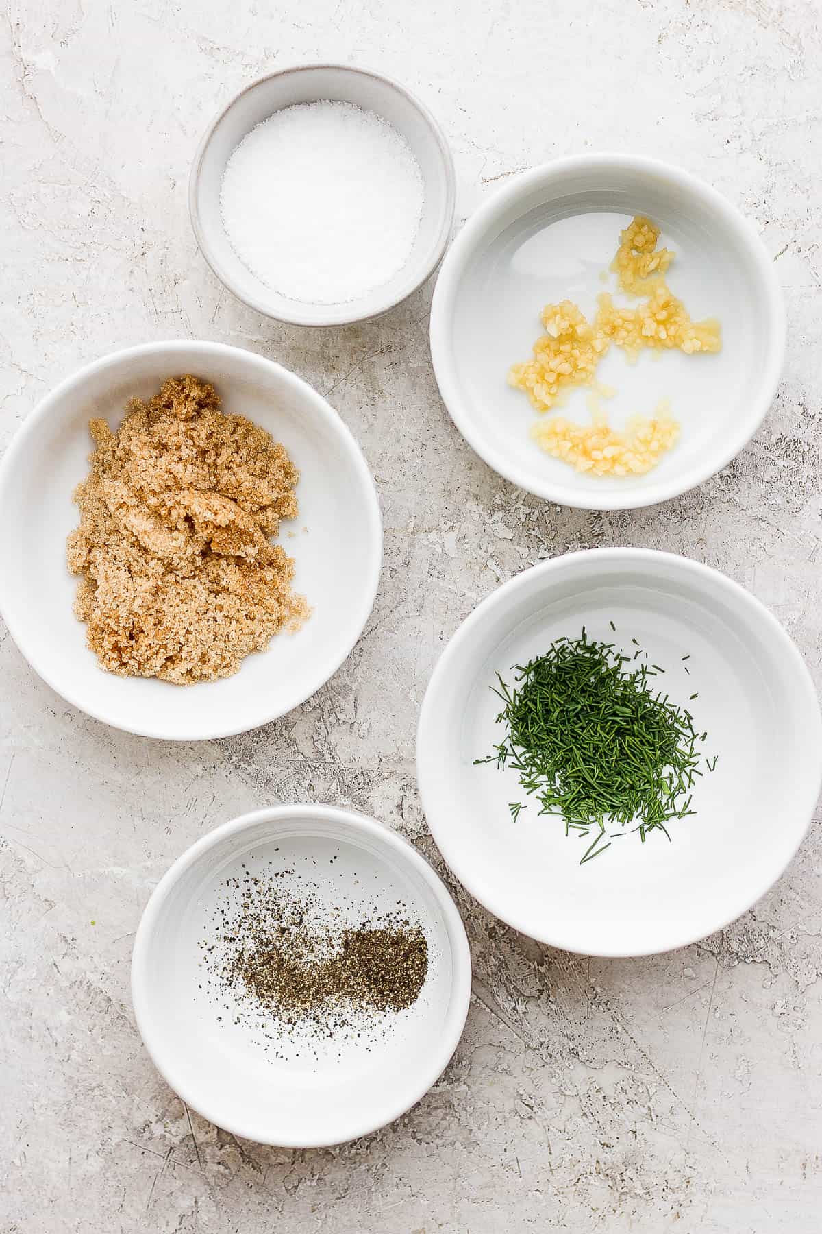 Ingredients for smoked salmon brine in separate dishes.