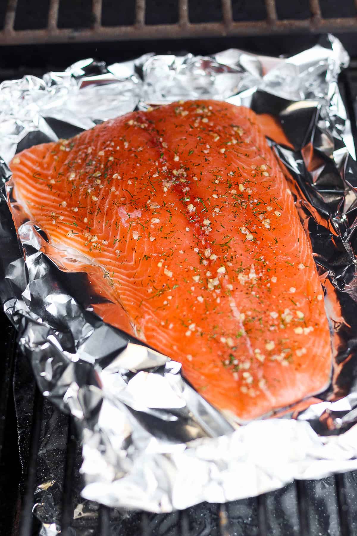 Dry brined salmon on aluminum foil on the smoker.