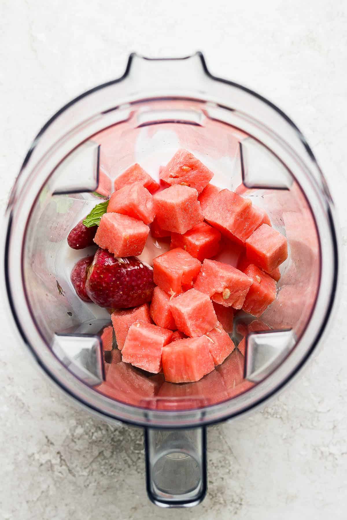 Watermelon smoothie ingredients in a blender.