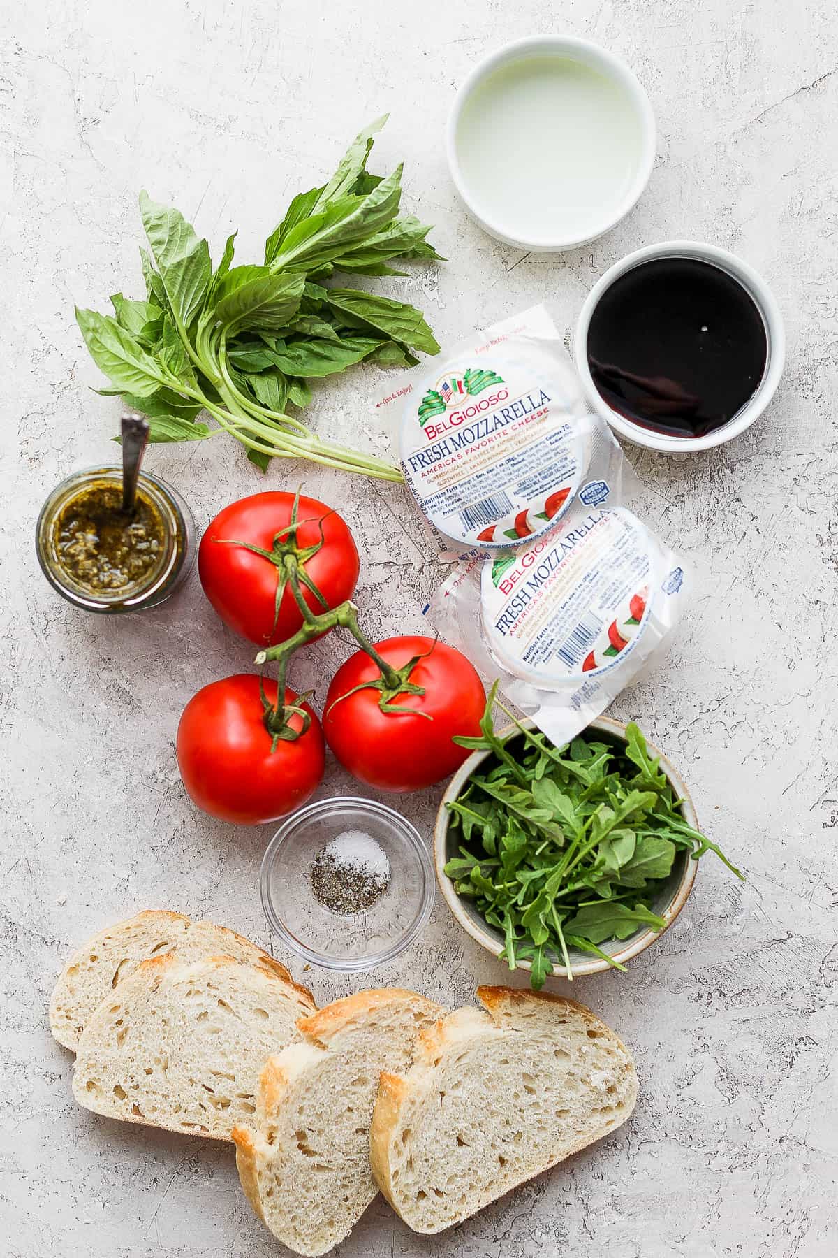 Ingredients for a caprese sandwich on the counter.