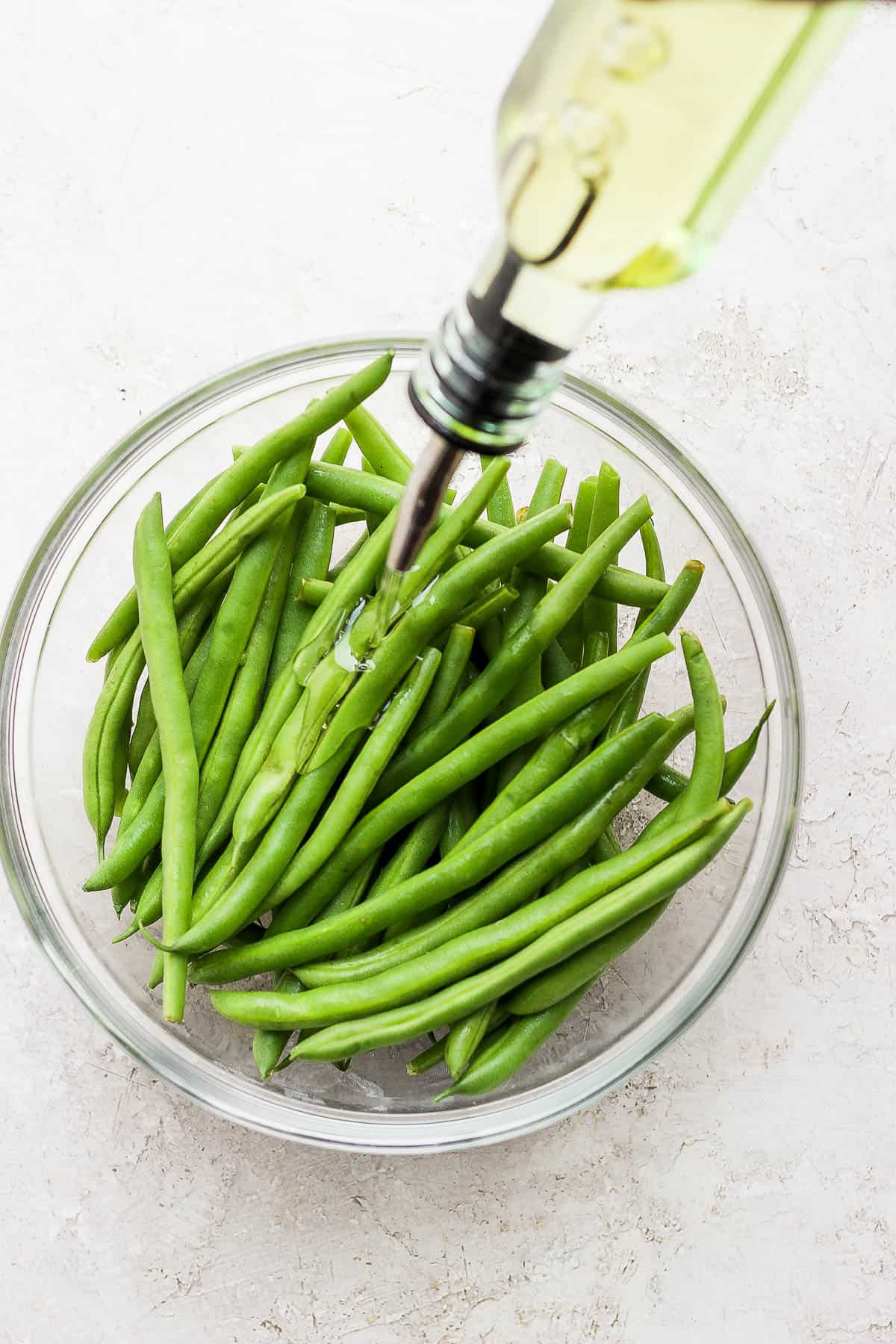 Olive oil drizzled on the fresh green beans.