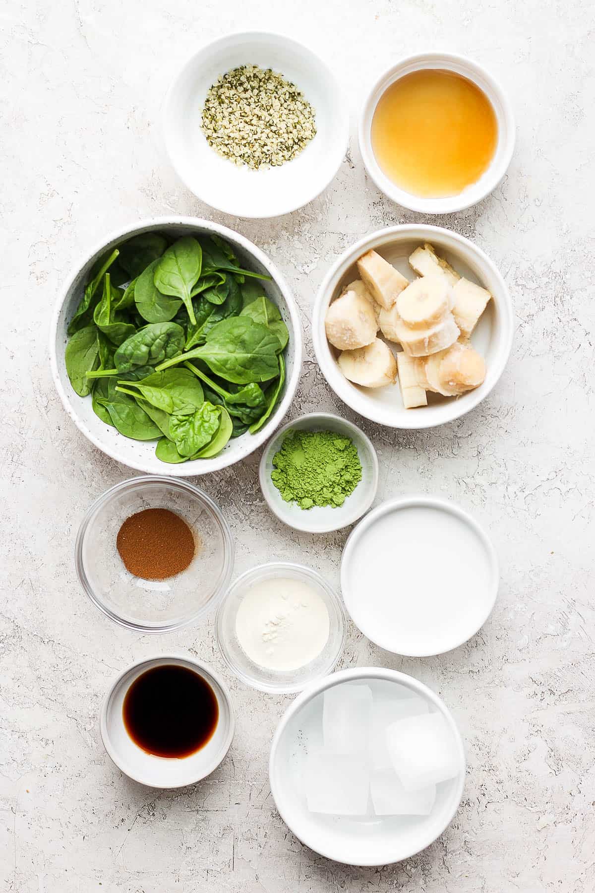Ingredients for a matcha smoothie in separate bowls.