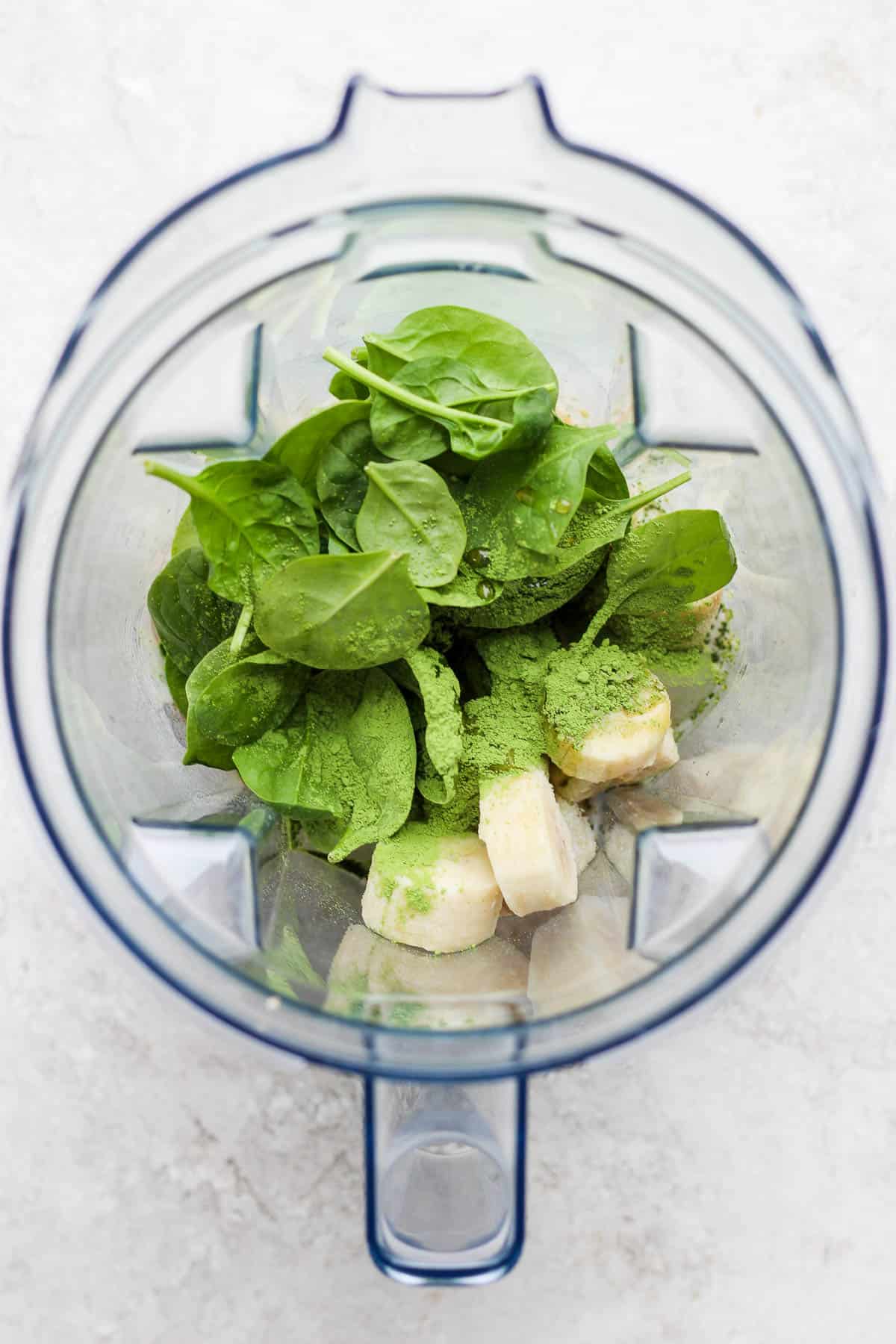 Matcha smoothie ingredients in a blender.