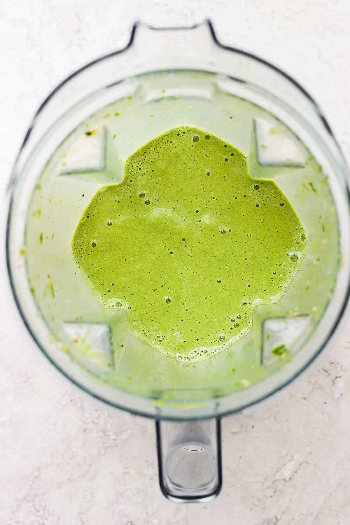 A blended matcha smoothie in a blender.