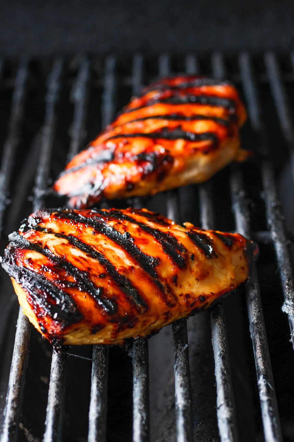 Two chicken breasts on the grill.