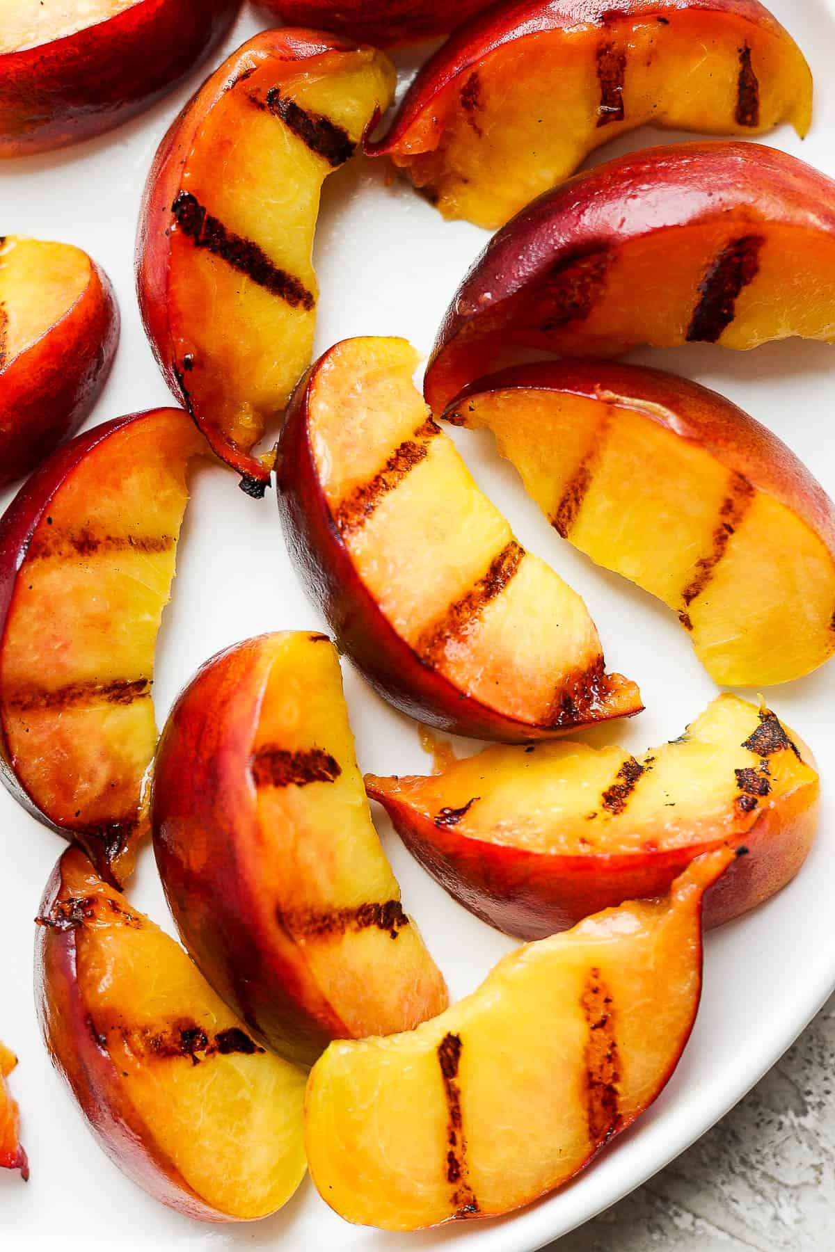 Grilled Peach wedges on a plate.