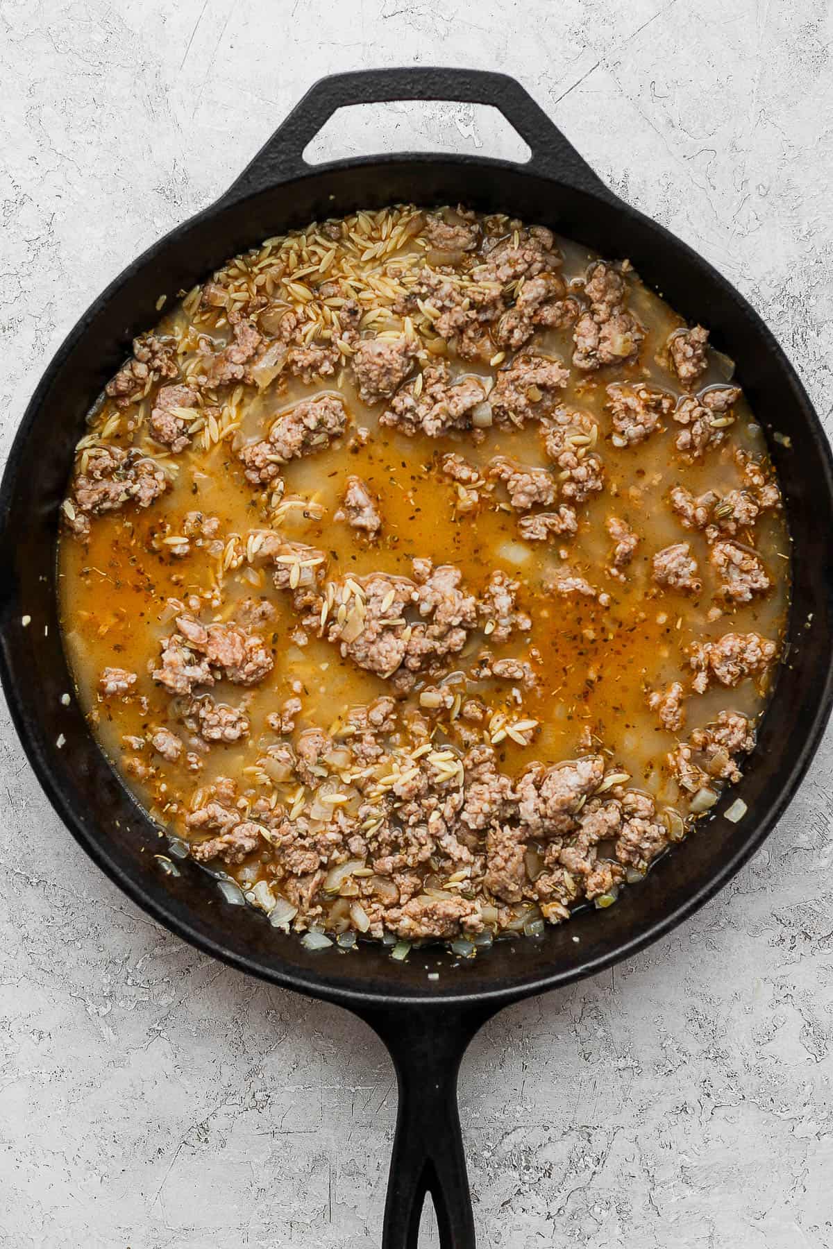 The chicken broth and orzo mixed in to cook.