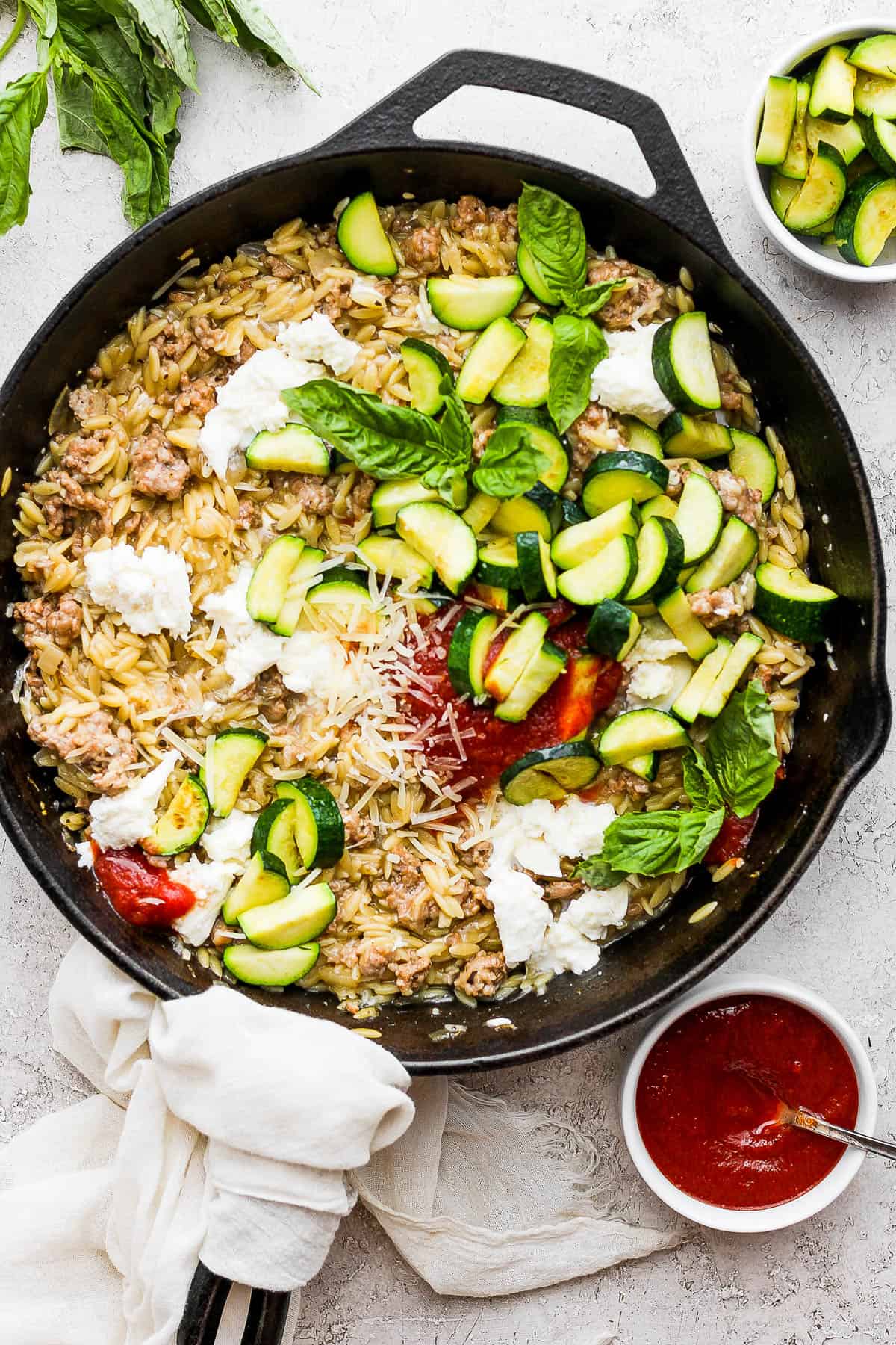 The sausage zucchini skillet with cheese mixed in and zucchini added.