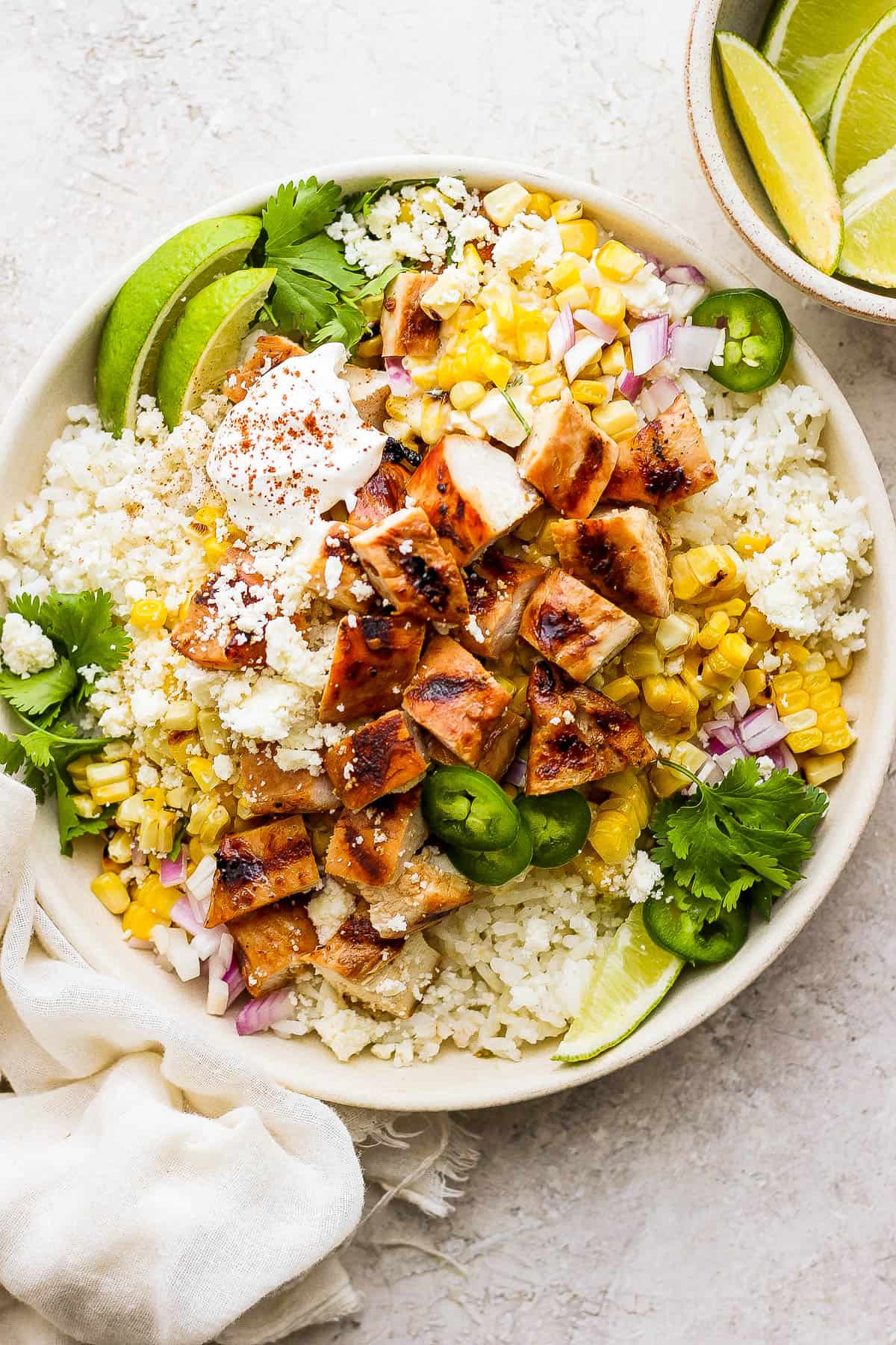 A fully topped street corn chicken rice bowl.
