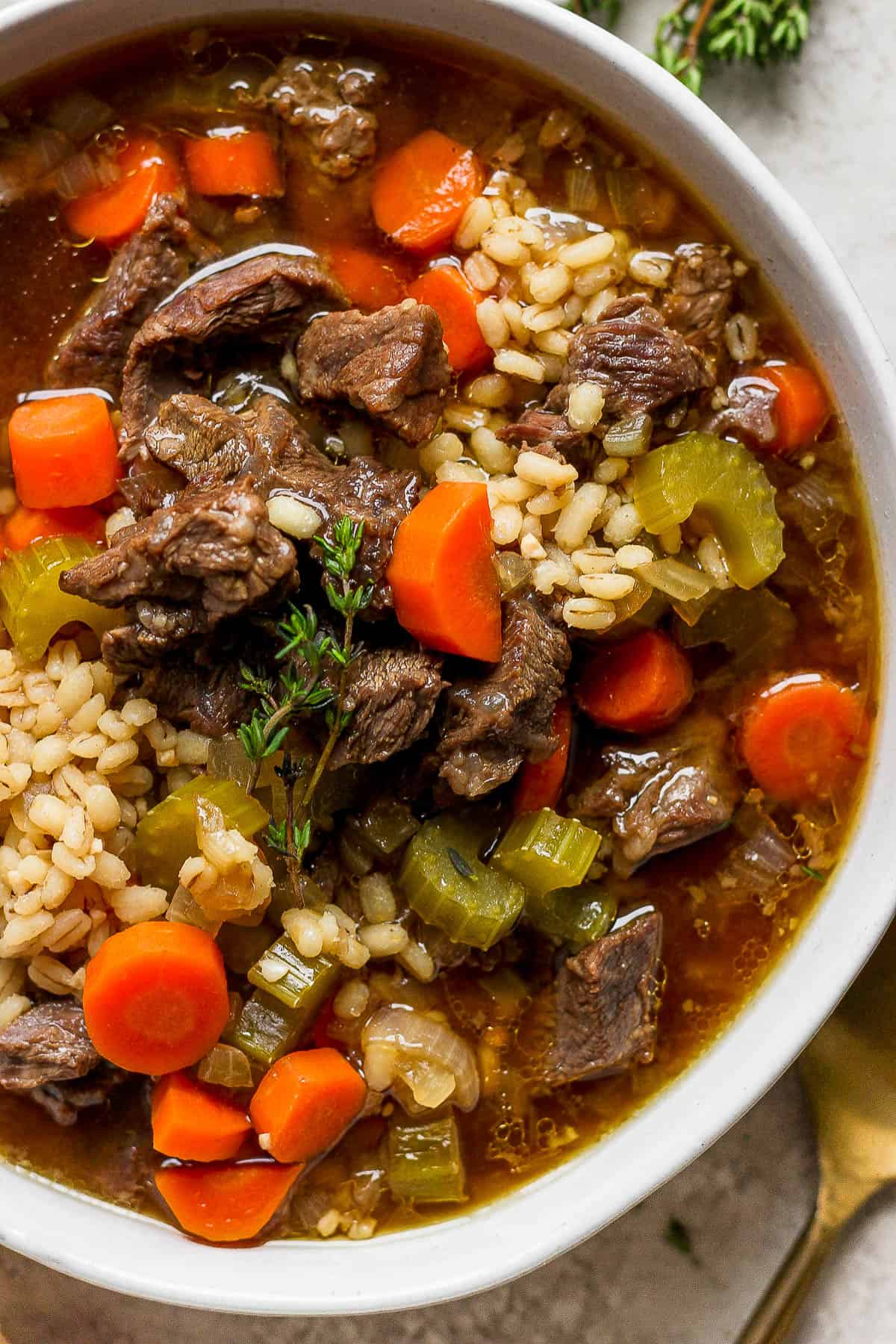 beef and barley soup in a bowl.