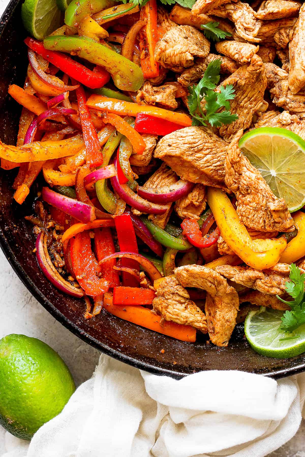 Fajita chicken and veggies together in the skillet.