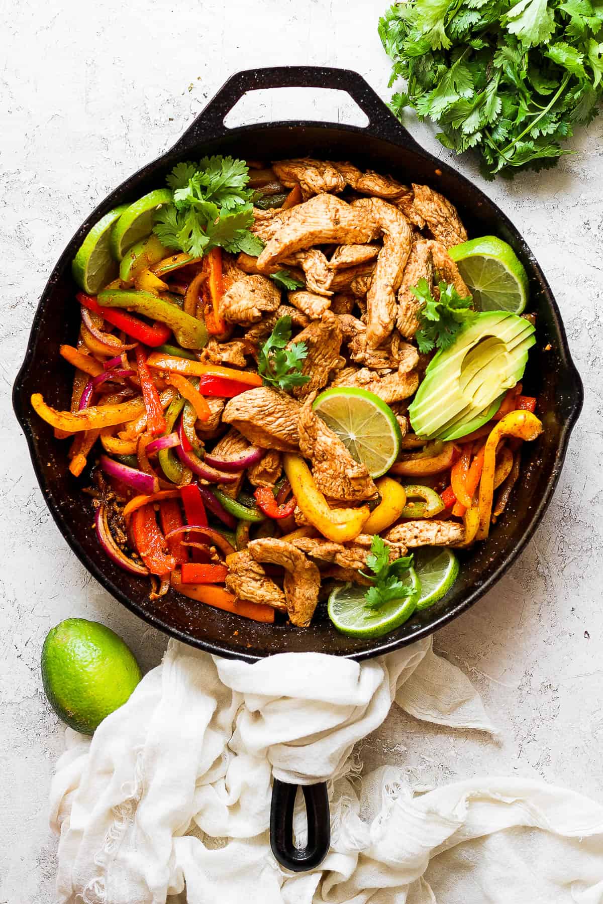 Marinated chicken tenders cooked in a cast iron skillet with fajita veggies.