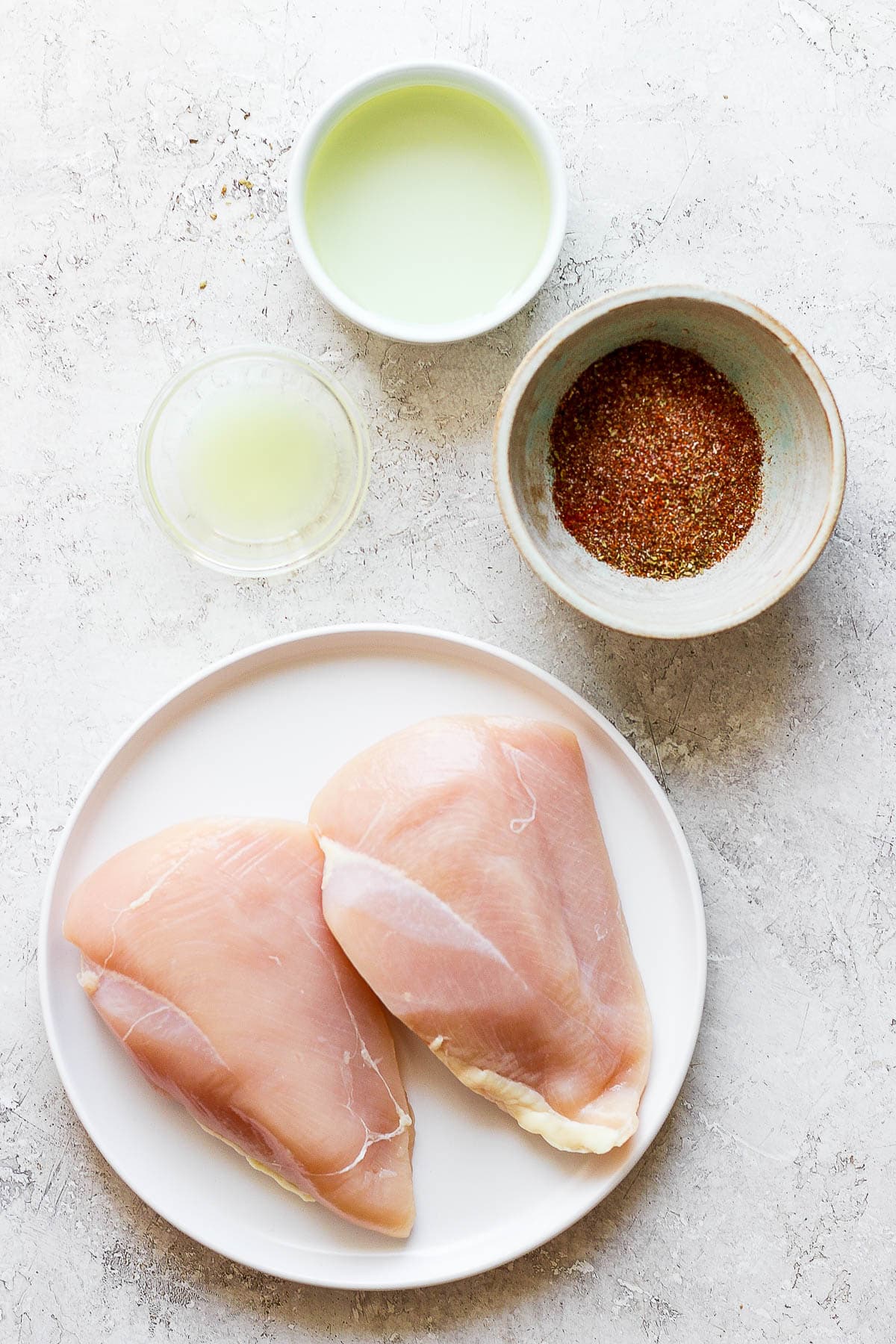 Ingredients for chicken fajita marinade in separate bowls.