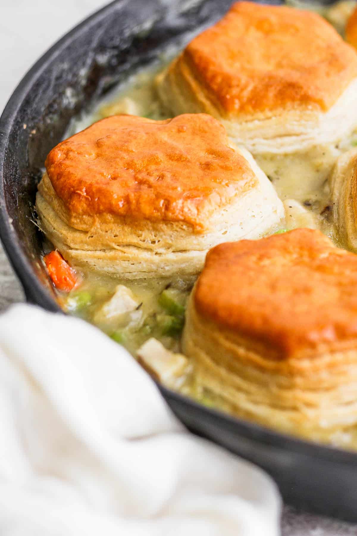 A close-up shot of the golden brown biscuits on top of the filling.