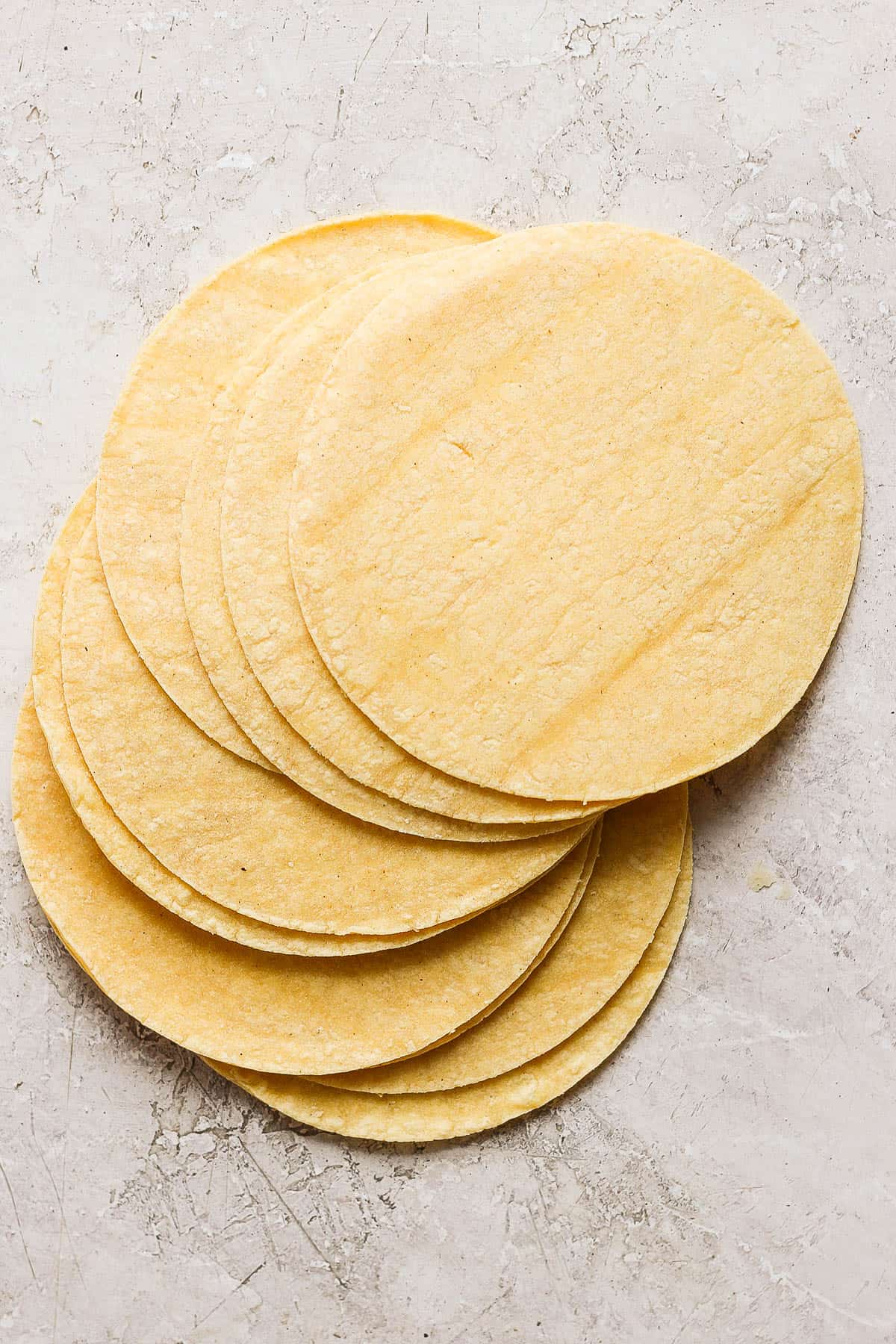 A stack of corn tortillas on the counter.