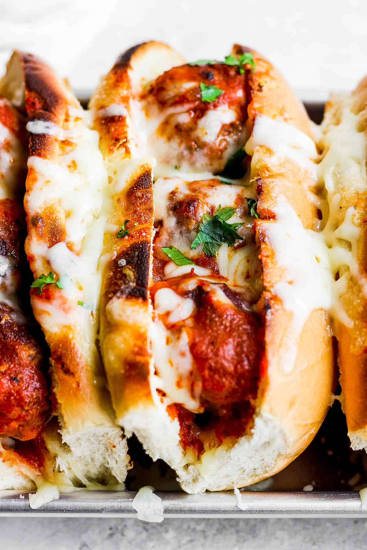 A close up of a fully broiled meatball sub.