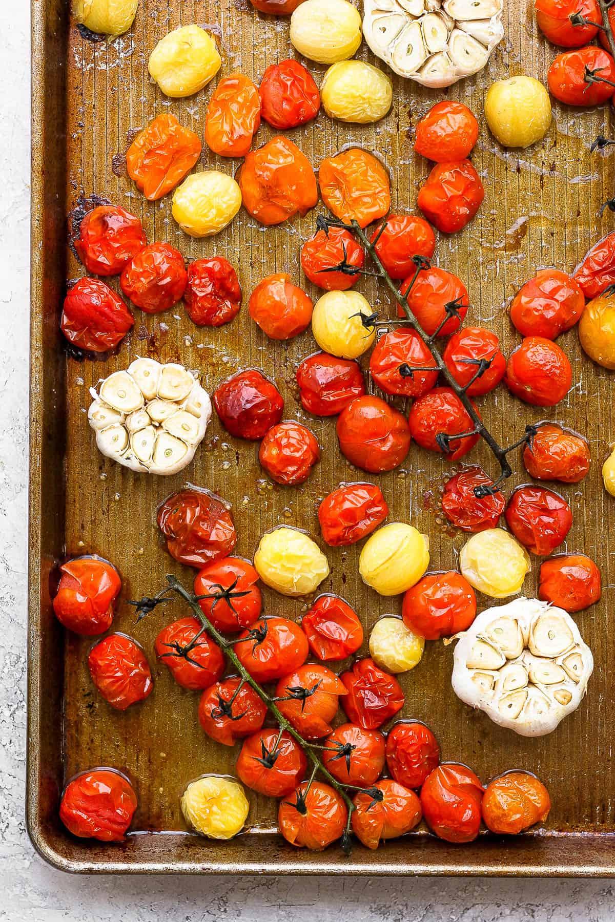Oven roasted cherry tomatoes on a baking sheet.