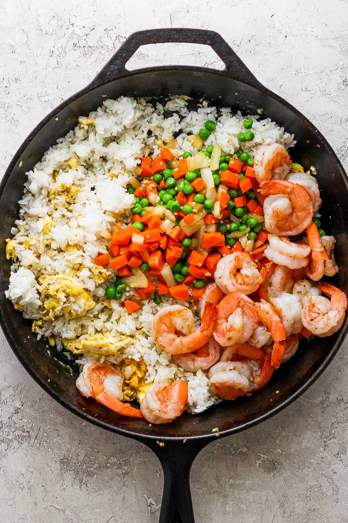 The rice, egg, veggies and shrimp separated out in the skillet.