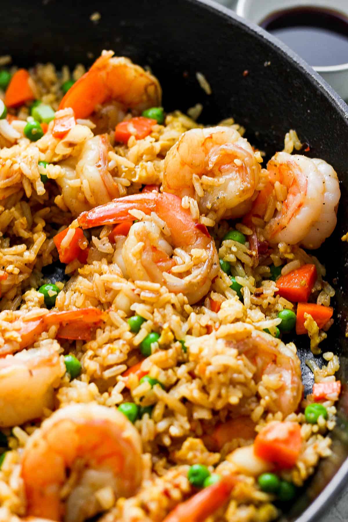 A close up of shrimp fried rice in a skillet.