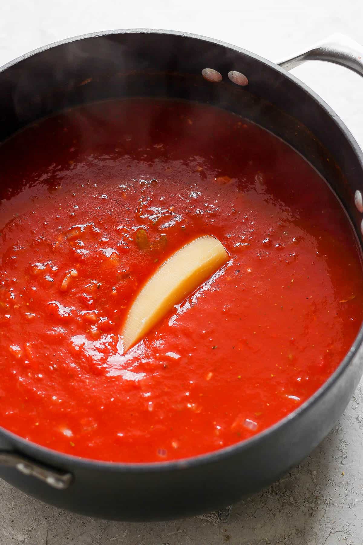 A parmesan rind added to the pot of tomato soup.