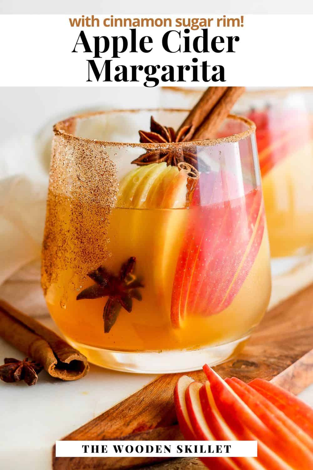 Pinterest image with a shot of an apple cider margarita with the title, "apple cider margarita with cinnamon sugar rim".