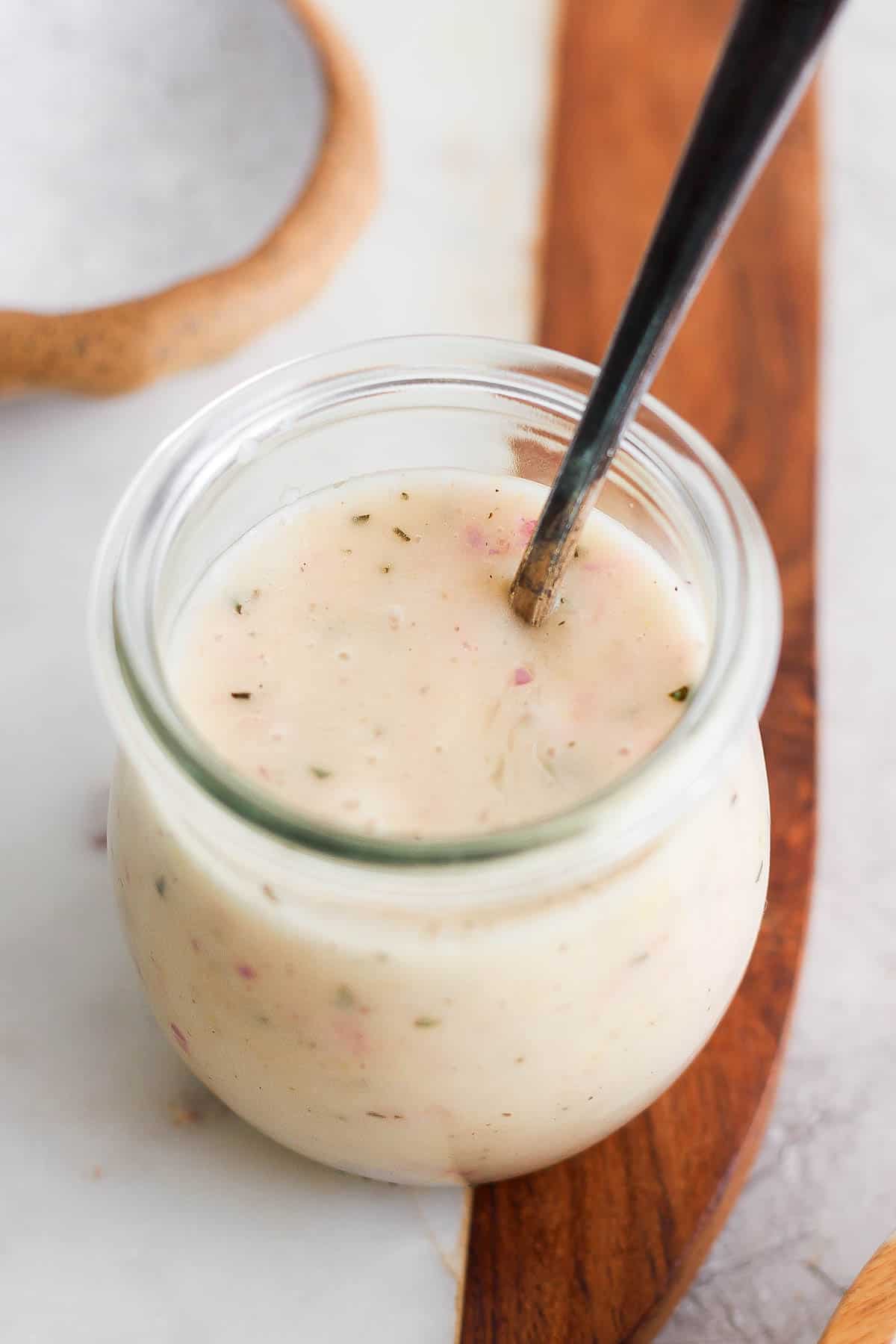 Champagne vinaigrette in a small glass jar.