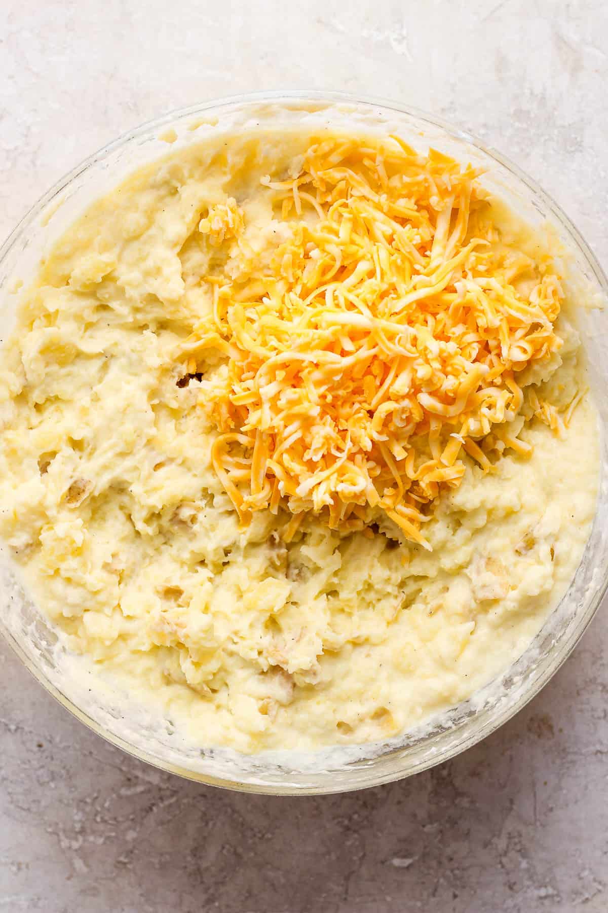 A half cup of the shredded cheese added to the mashed potatoes.