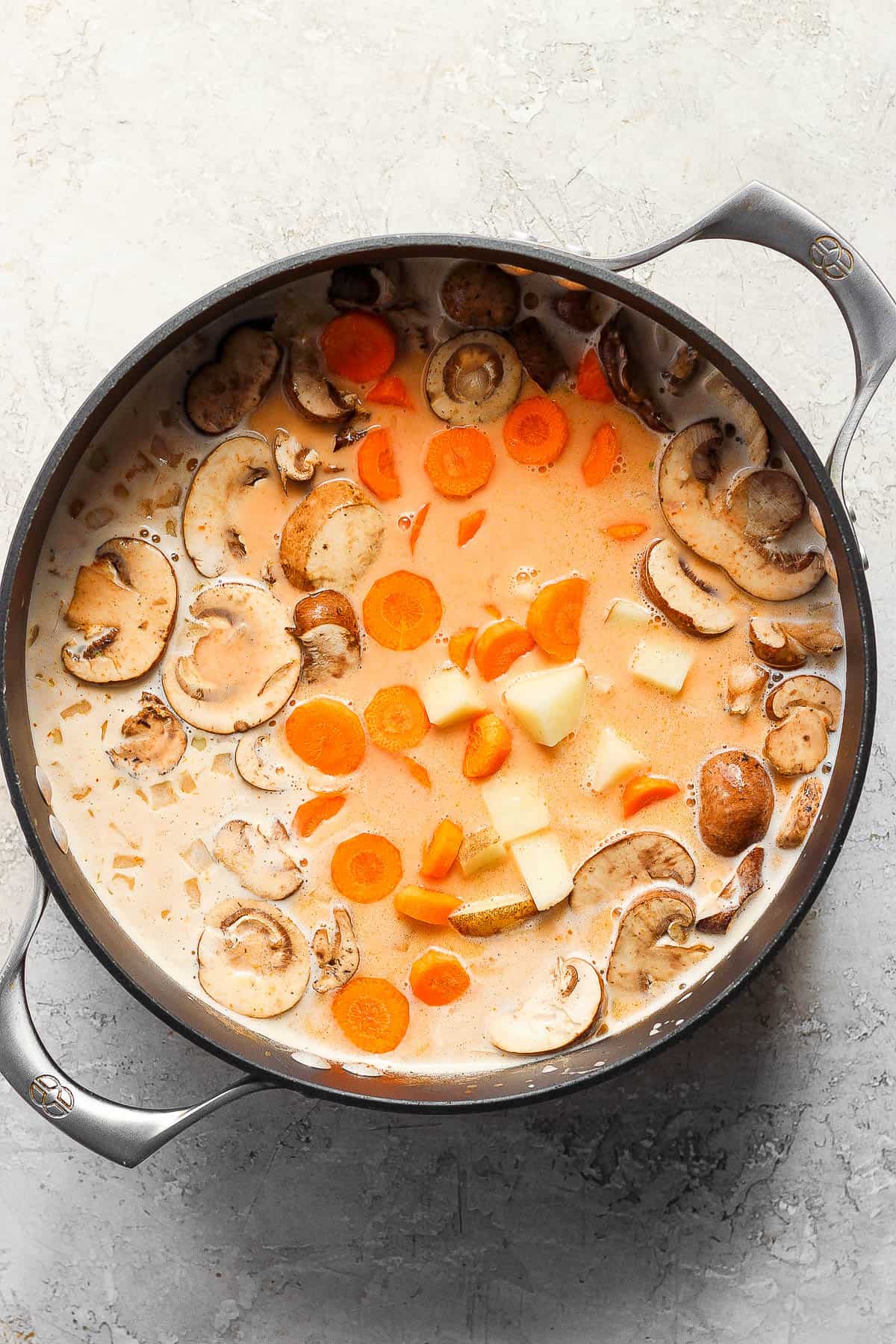 Carrots, mushrooms and bell pepper added to the soup and brought to a simmer.