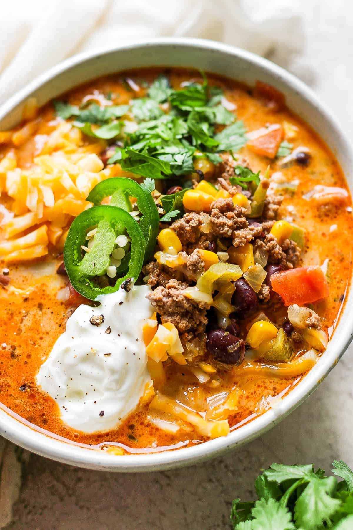 A fully garnished bowl of creamy taco soup.