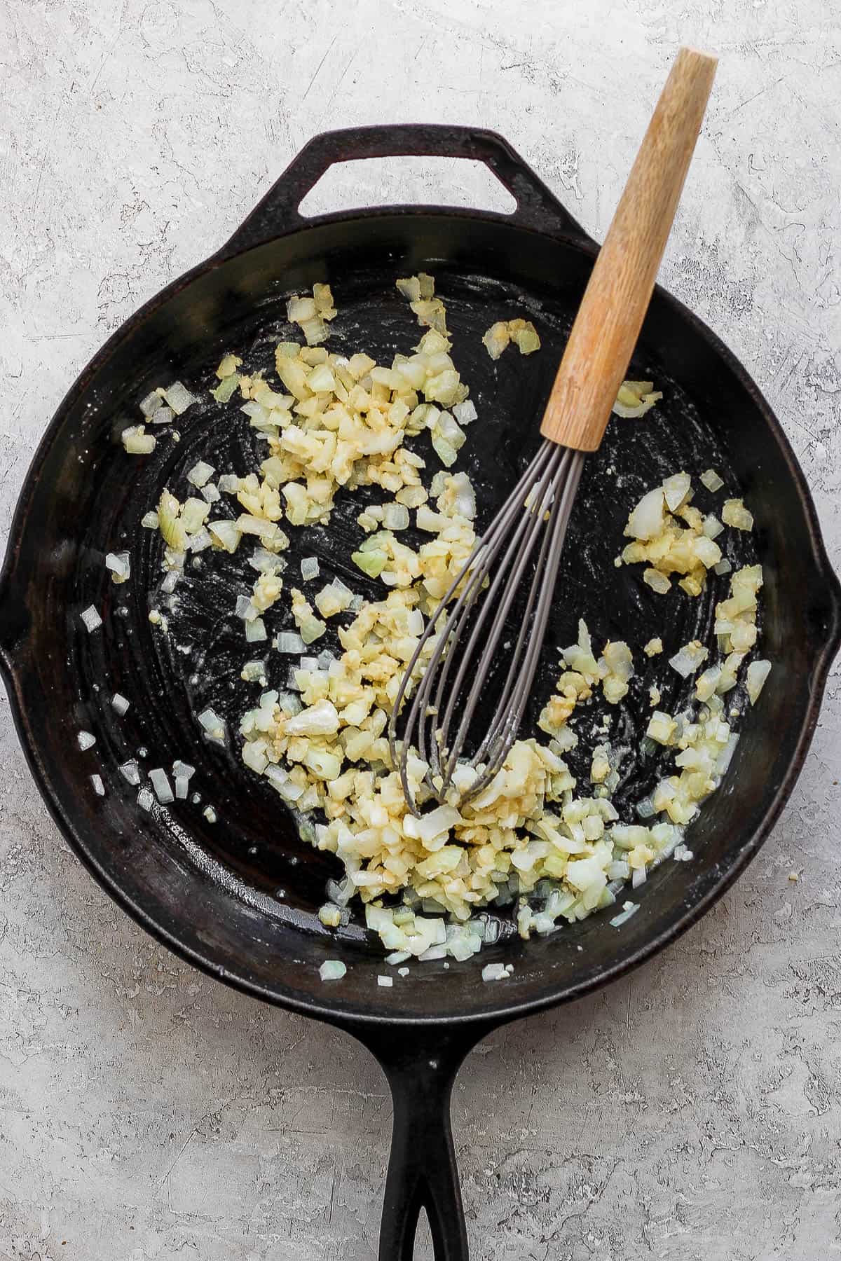 Flour whisked into the butter, onion, and garlic in a large skillet.