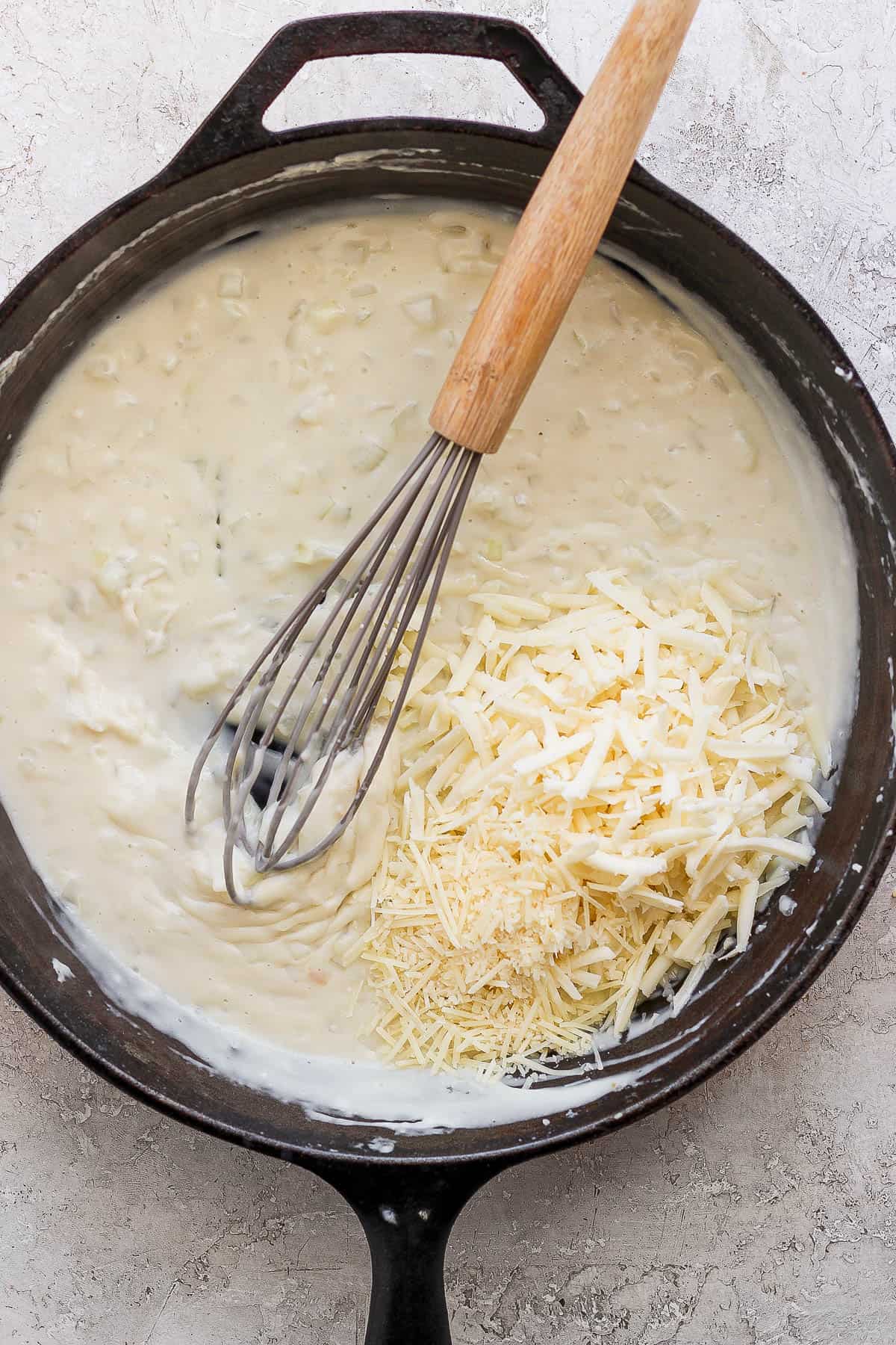 The skillet after all of the broth and cream were whisked in and then the shredded cheese added to the pan.