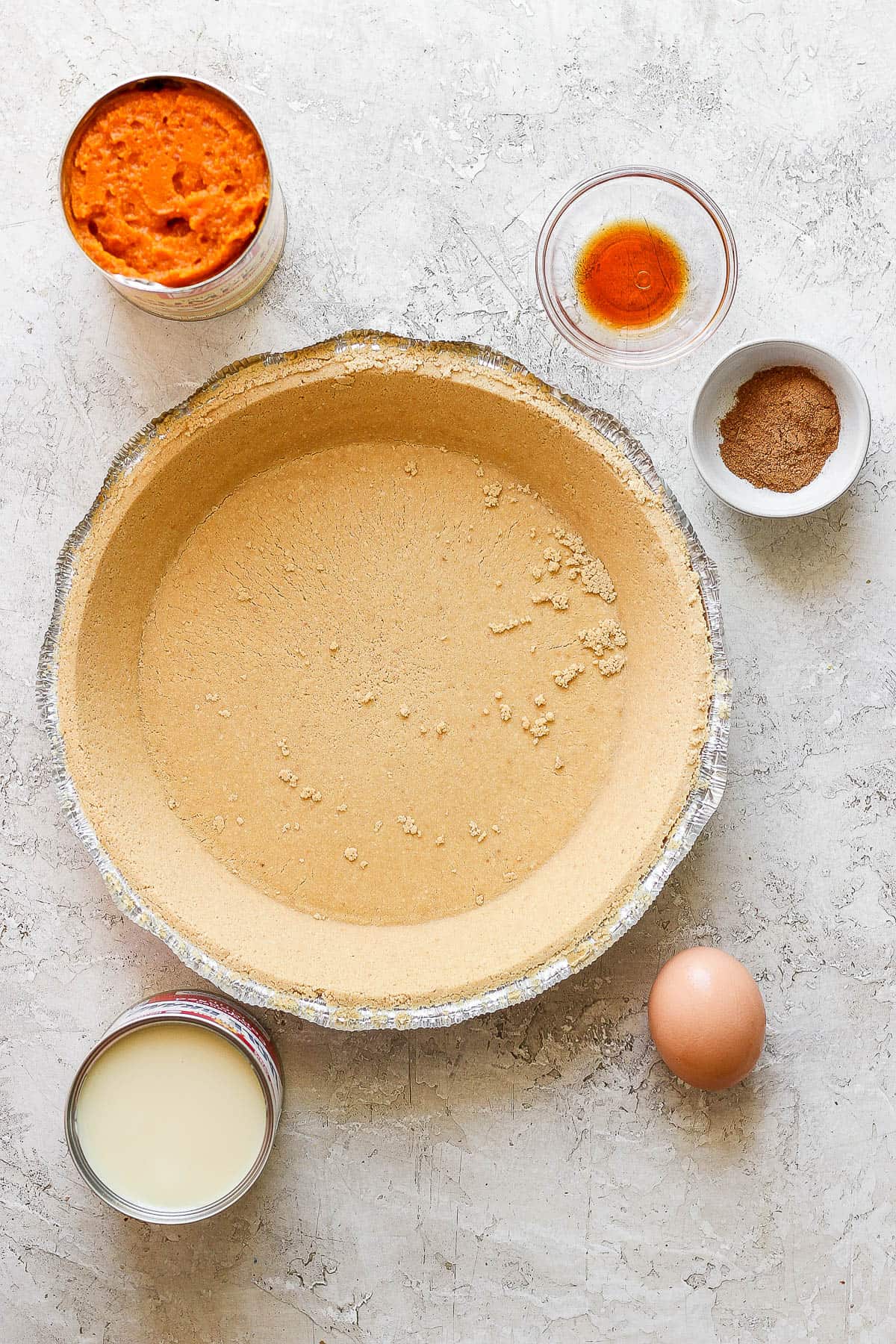 Ingredients for an easy pumpkin pie on the counter.